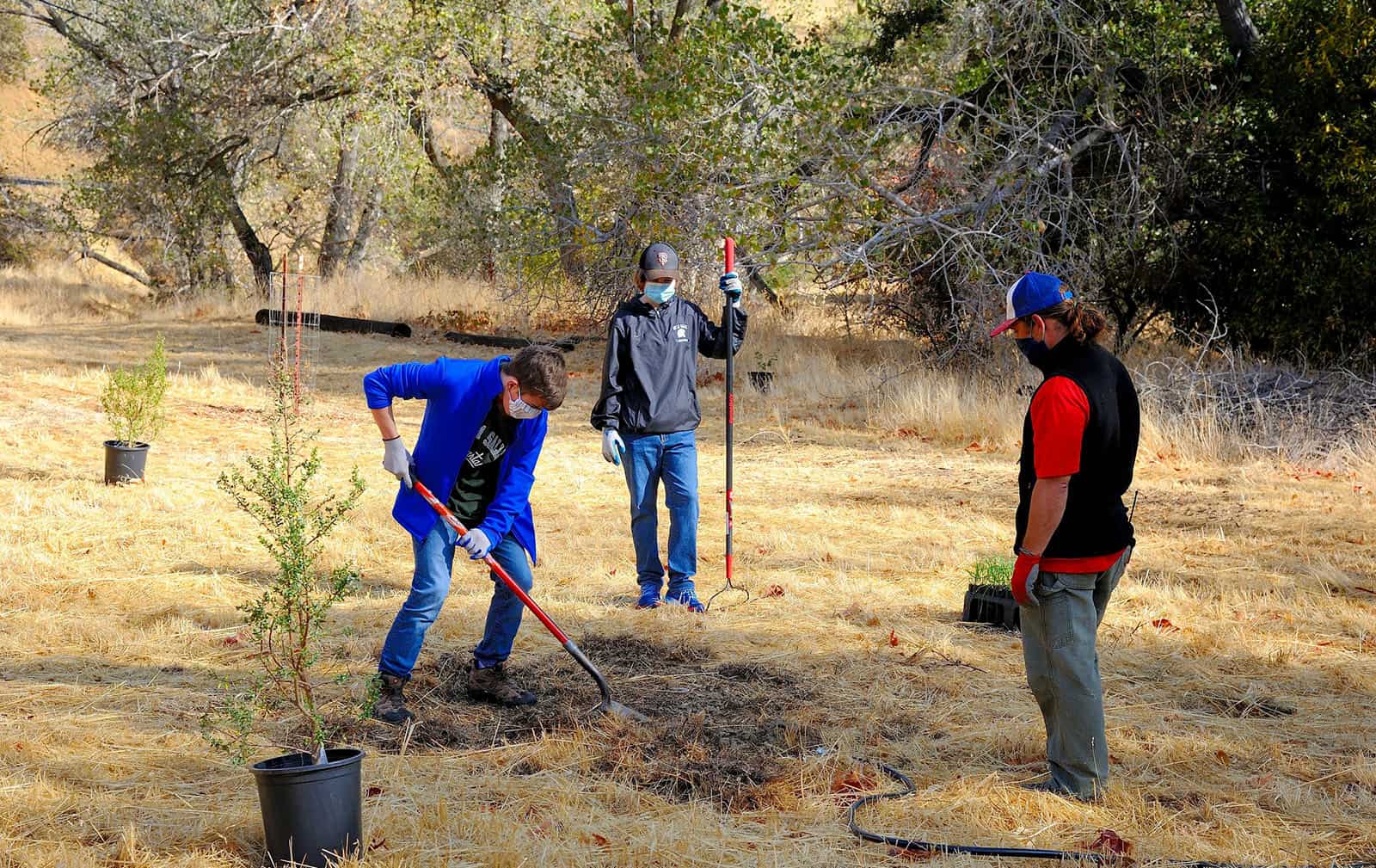 two students planting a native shrub at the Save Mount Diablo Big Bend property in the Marsh Creek watershed