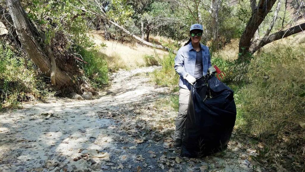 A Diablo Restoration Team member gathering up stinkwort at Save Mount Diablo's Marsh Creek 1 and 7 properties