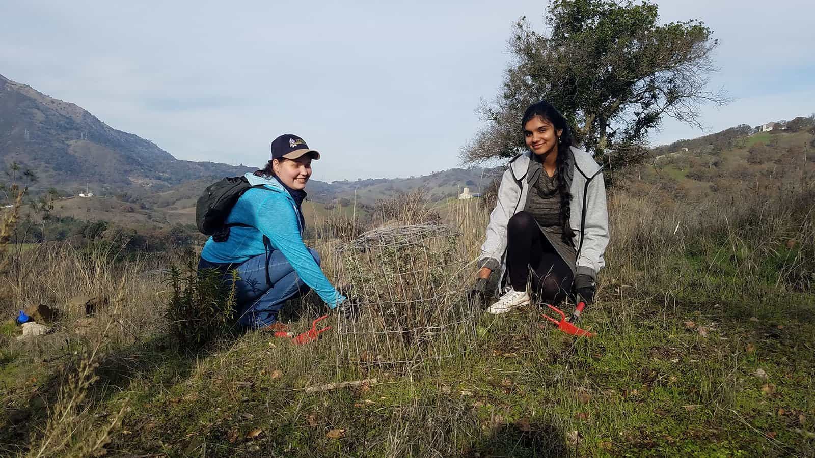 two young women volunteering for a Diablo Restoration Team workday at the Marsh Creek 6 property