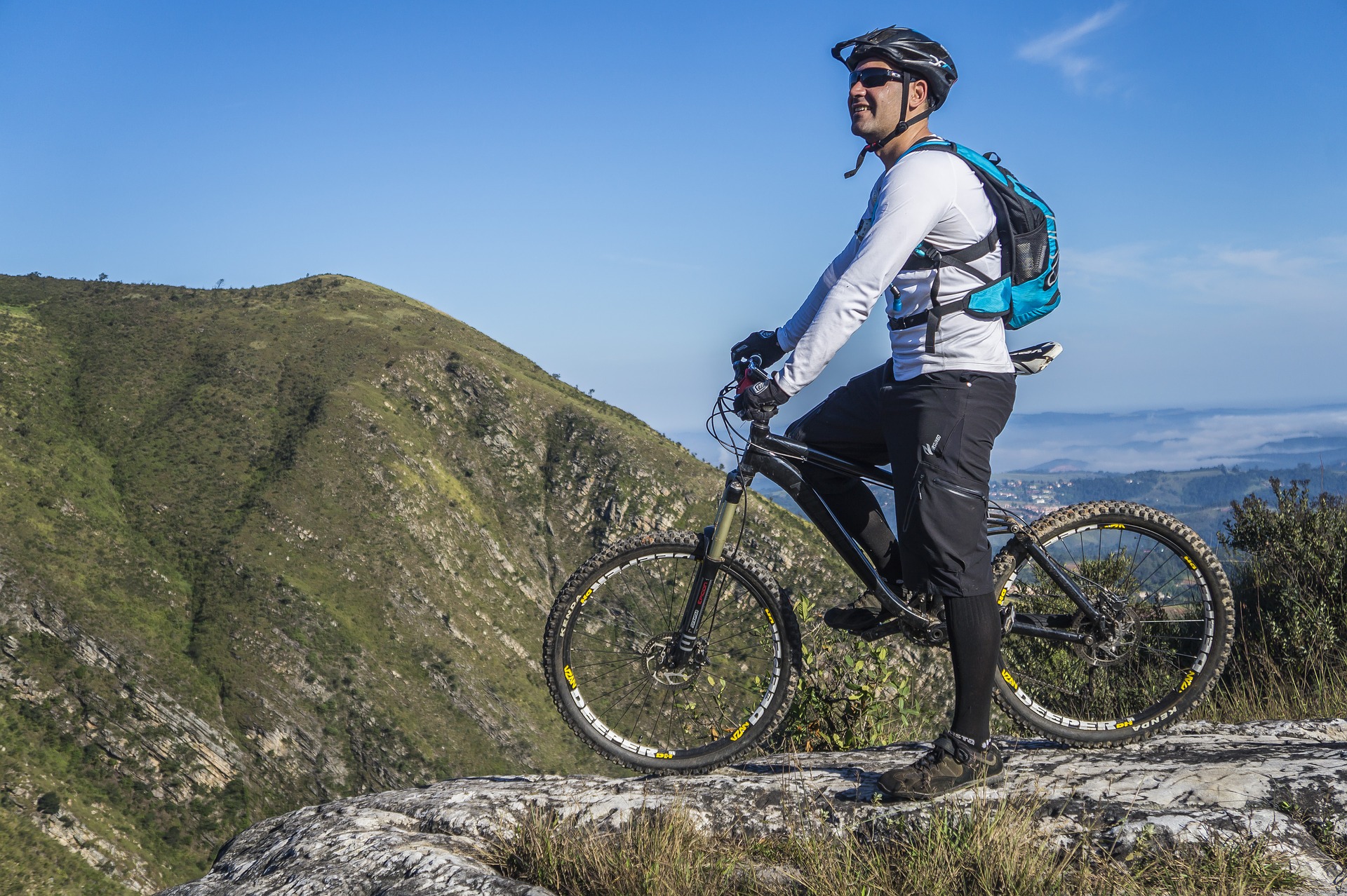 A mountain biker on his bike looking out over the hills