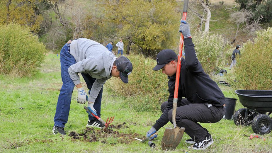 two students planting native plants at Marsh Creek 4