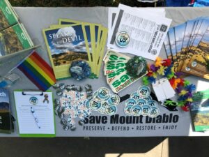 table with handouts that contain infornmation about pride and save mount diablo