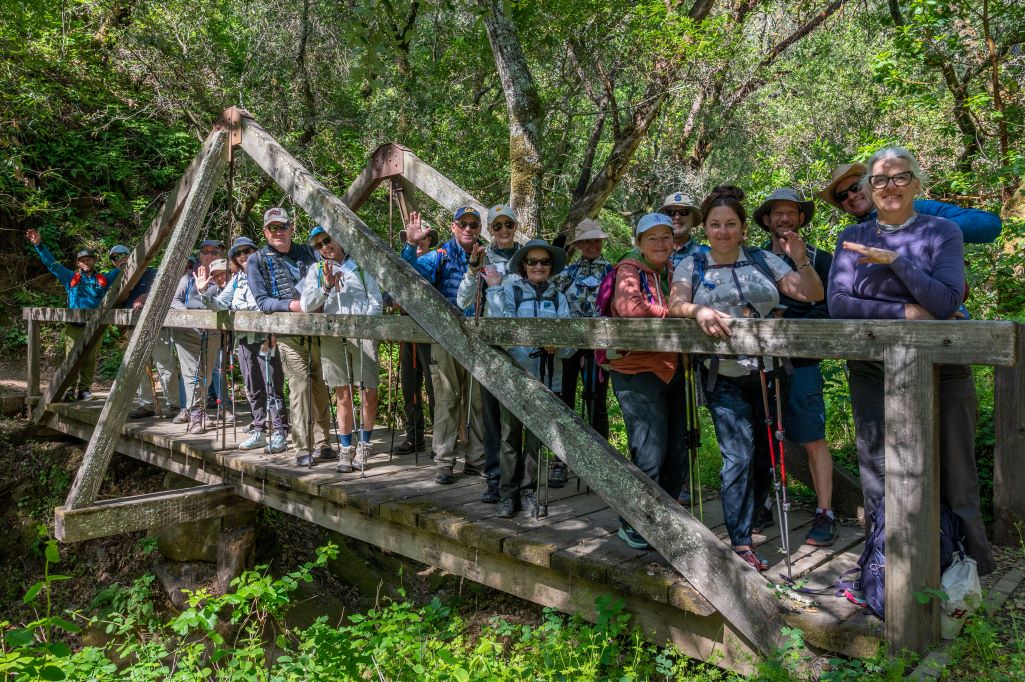 Hikers posing for a photo on a bridge in Madrone Canyon
