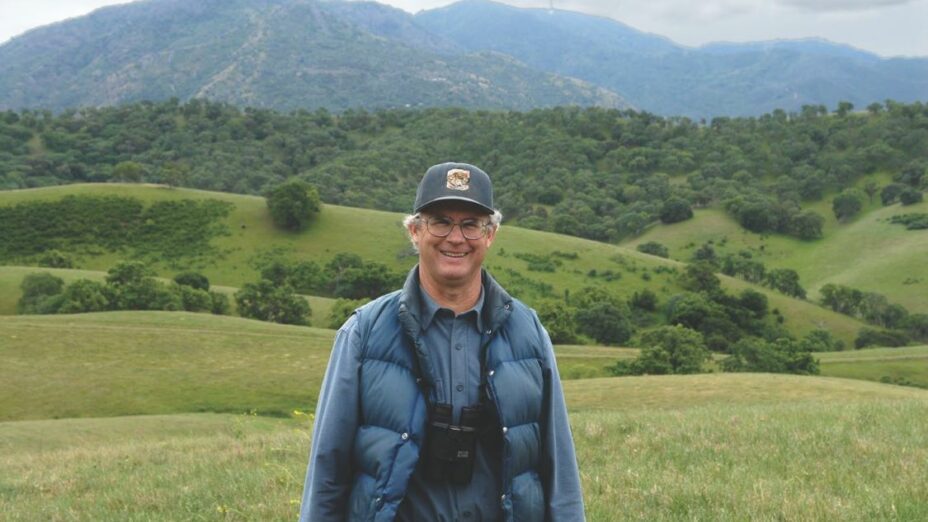 Malcolm in front of Mount Diablo's green rolling hills