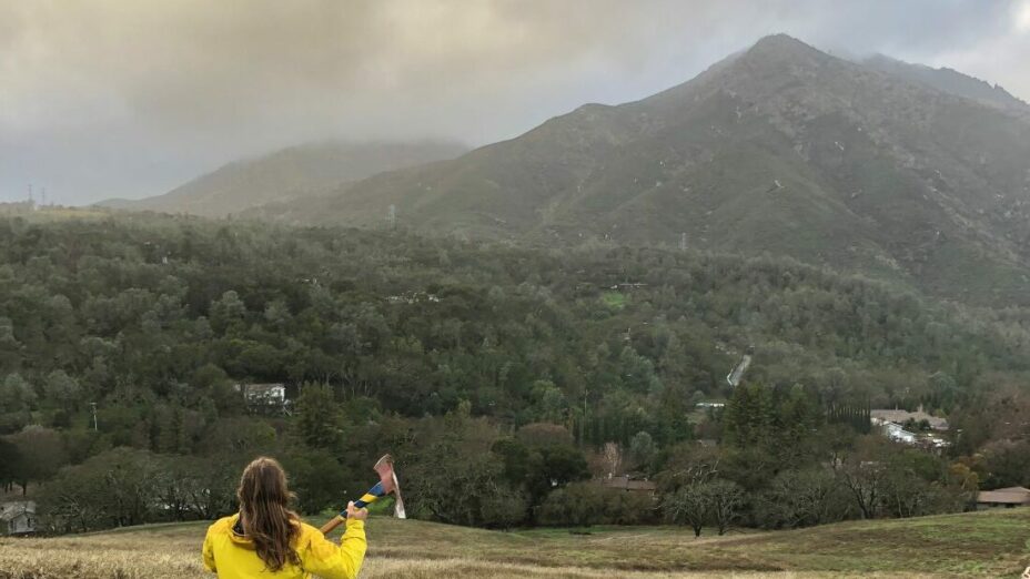 sean burke holding an axe facing mount diablo's north peak in the rain