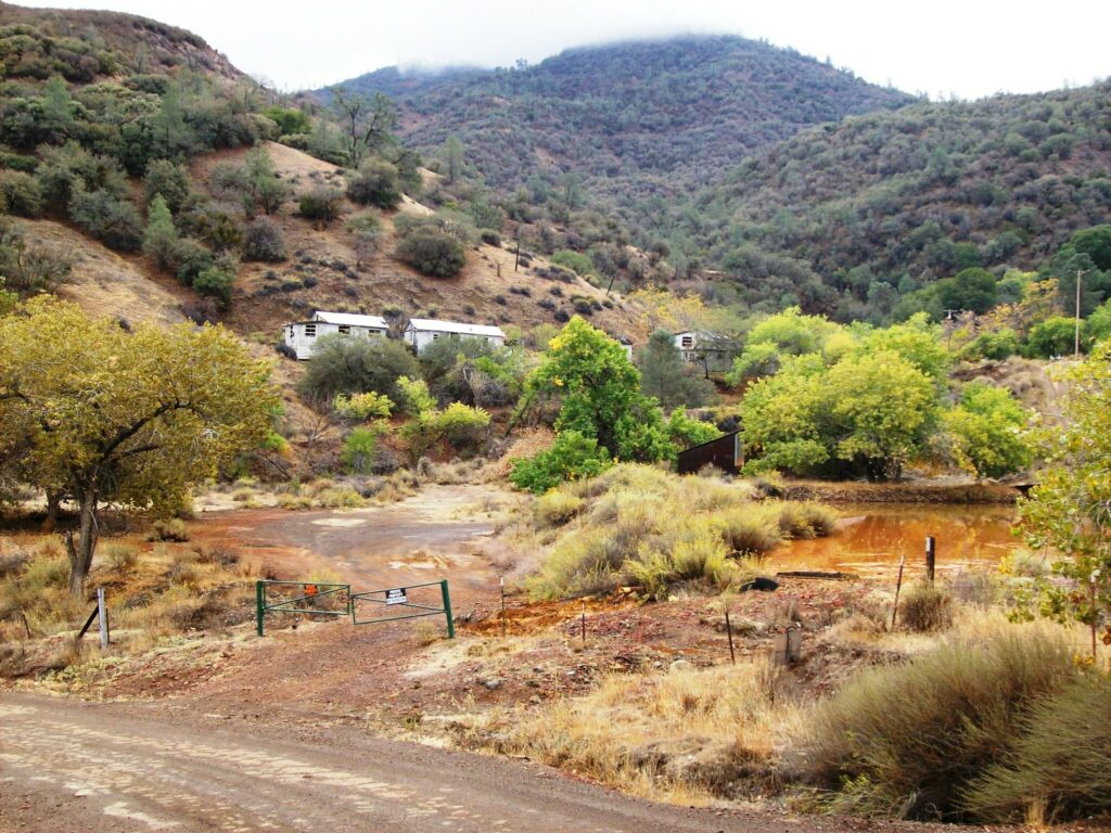 New Idria Ghost Town and the orange runoff of San Carlos Creek, San Benito County, California.