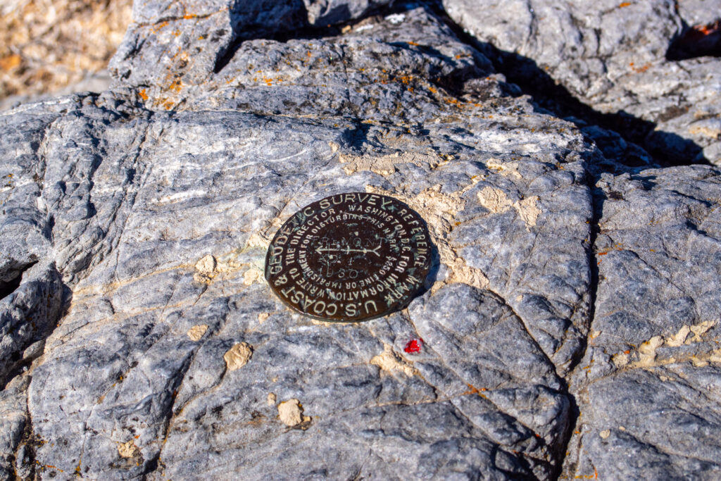 A US Coast & Geodetic Survey marker stamped into the marble-covered Fremont Peak