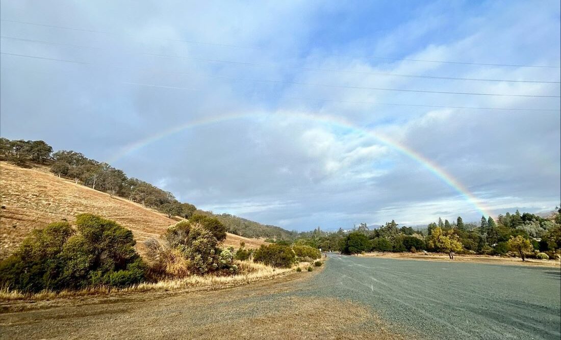 a rainbow over a fire road