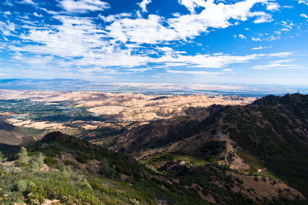 Partly cloudy blue skies over golden hills and the chaparral slopes of Mount Diablo