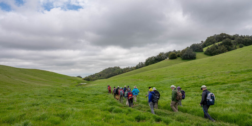 Four Days Diablo group traversing an open hilltop