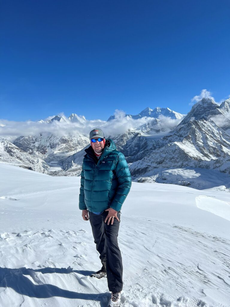 Ted Clement posing in front of the Himalayas