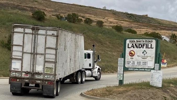 a truck enters john smith landfill