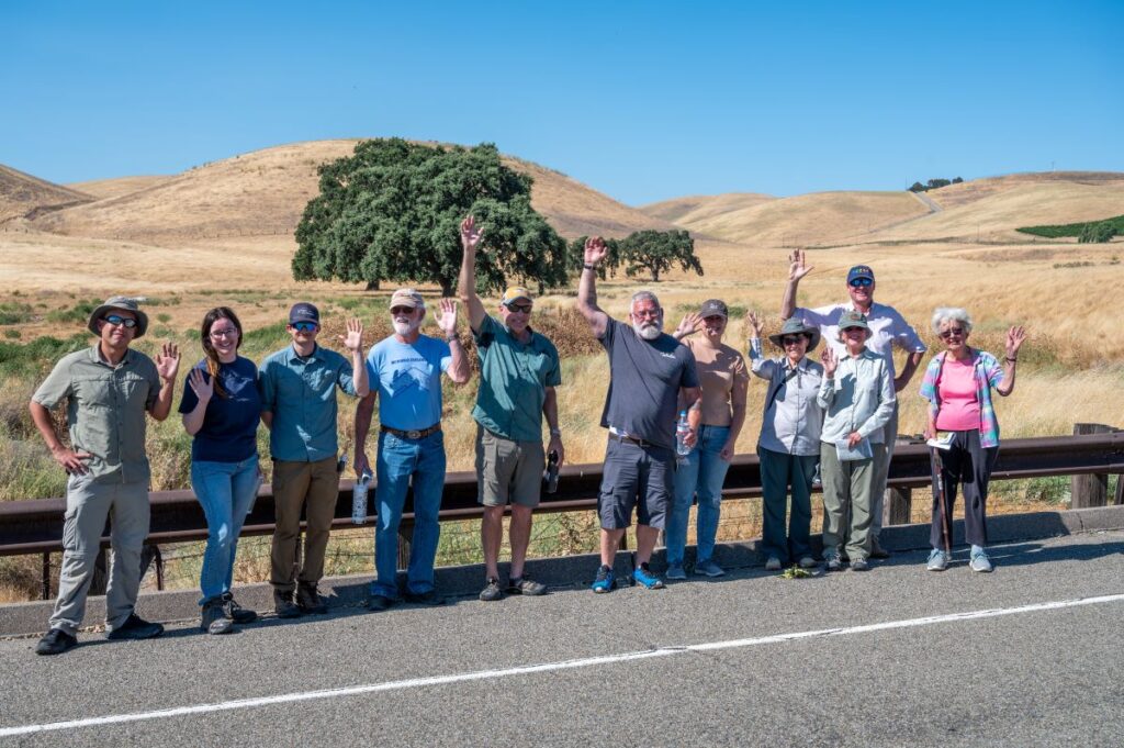 People posing in front of hills during Crosby Property Tour